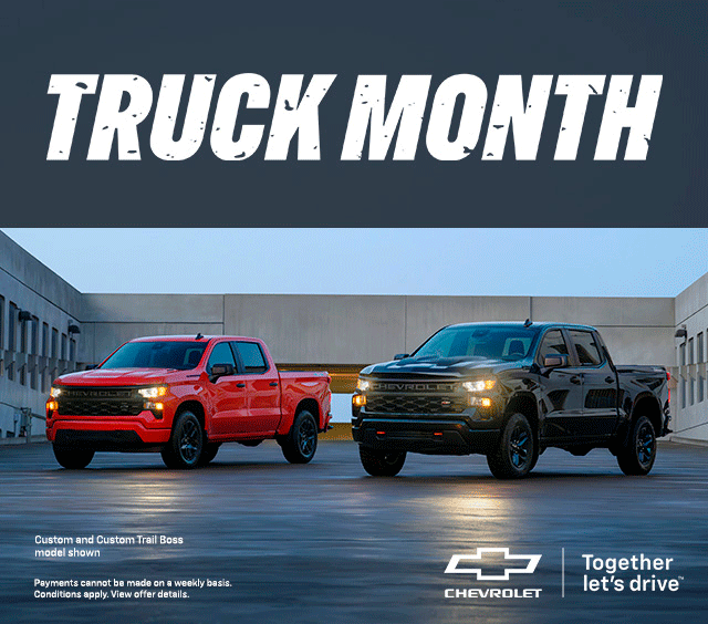 Advertisement for the 2025 Chevrolet Silverado LD Custom Trail Boss, featuring a 0% financing offer for up to 72 months. The image showcases a black Silverado truck parked in a forest setting with Chevrolet branding and conditions disclaimer at the bottom.
